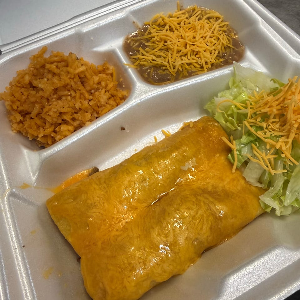 A takeout container with two cheese enchiladas, rice, refried beans, and a side salad.